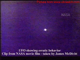 A bright point of light against a dark blue background: a frame from NASA film taken by astronaut James McDivitt